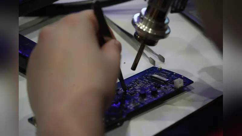 Small repair tools laid out on an electronics workbench